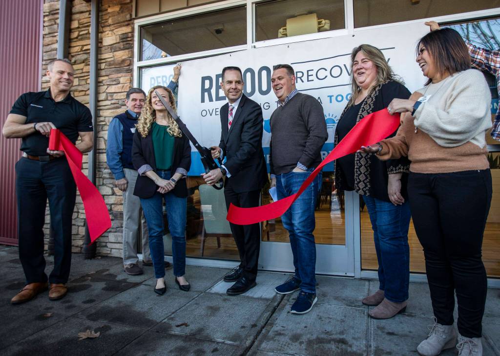 Marysville Mayor Jon Nehring cuts the ribbon at the open house for the Reboot Recovery on Monday, in Marysville. (Olivia Vanni / The Herald)