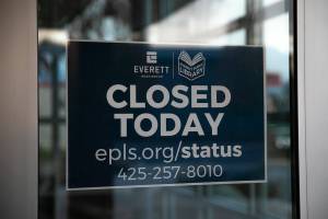 A closed sign is posted inside the front doors at the Evergreen Branch of the Everett Public Library on Friday, Nov. 11, 2022, in Everett, Washington. (Ryan Berry / The Herald)