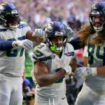 Seattle Seahawks running back Kenneth Walker III, middle, is congratulated by tight end Noah Fant, left, and tight end Colby Parkinson (84) after scoring against the Arizona Cardinals during the second half of an NFL football game in Glendale, Ariz., Sunday, Nov. 6, 2022. (AP Photo/Matt York)