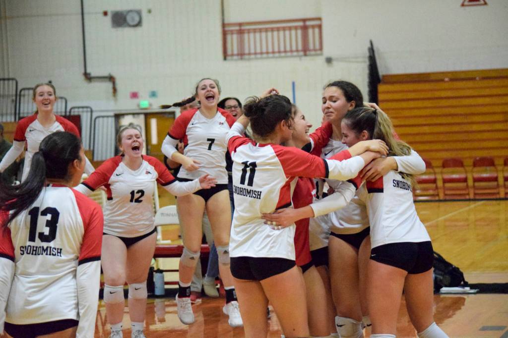 Snohomish volleyball players celebrates their win over Ferndale in a 3A District 1 Tournament semifinal match on Thursday, Nov. 10, 2022, at Marysville Pilchuck High School. (Katie Webber / For The Herald)