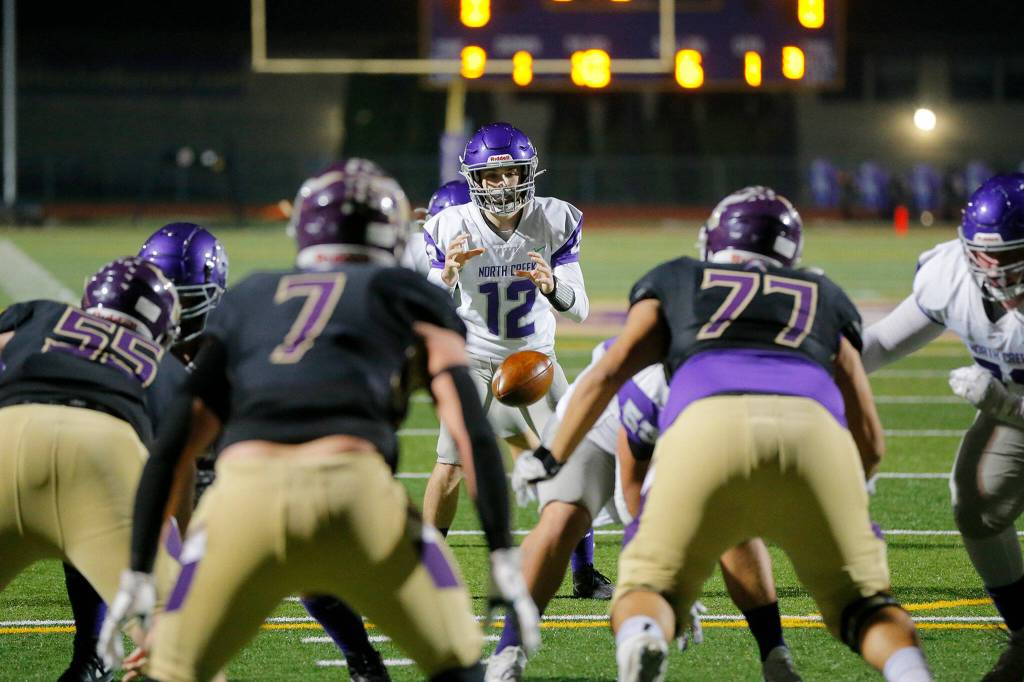 North Creeks Luc Naldrett takes a snap during a playoff game against Lake Stevens on Friday, Nov. 11, 2022, at Lake Stevens High School in Lake Stevens, Washington. (Ryan Berry / The Herald)
