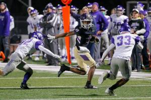 Lake Stevens’ Cassidy Bolong-Banks tris to take a reception for a first down during a playoff game against North Creek on Friday, Nov. 11, 2022, at Lake Stevens High School in Lake Stevens, Washington. (Ryan Berry / The Herald)