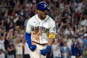 Seattle Mariners' Julio Rodriguez celebrates while rounding the bases after hitting a solo home run off Atlanta Braves relief pitcher Kenley Jansen during the ninth inning of a baseball game, Sunday, Sept. 11, 2022, in Seattle. The Mariners won 8-7. (AP Photo/Stephen Brashear)