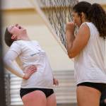 Charlie Thomas, left, and Hannah Johnson, right, laugh together before the start of a drill during practice on Tuesday, Nov. 15, 2022 in Bothell, Washington. (Olivia Vanni / The Herald)