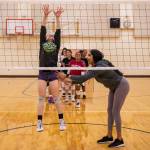 Coach Yuremi Lopez, right, yells words of encouragement while Cody Harmon, left tries to jump and reach above the net during a drill on Tuesday, Nov. 15, 2022 in Bothell, Washington. (Olivia Vanni / The Herald)