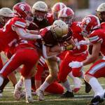 Stanwoods defense swarms Lakewood quarterback Nash Espe during a game Sept. 2 at Lakewood High School in Arlington. (Ryan Berry / The Herald)