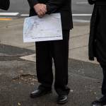 Lynnwood City Council member George Hurst holds a map marking fatal traffic collisions in Snohomish County since 2013 during a press conference for World Day of Remembrance for Road Traffic Victims on Monday in Everett. (Olivia Vanni / The Herald)