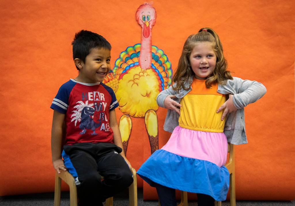 Jake Martinez-Torralba, left, smiles while and Evelyn Ward, right, does her best impression of a turkey at Central Primary School on Tuesday, Nov. 22, 2022 in Snohomish, Washington. (Olivia Vanni / The Herald)
