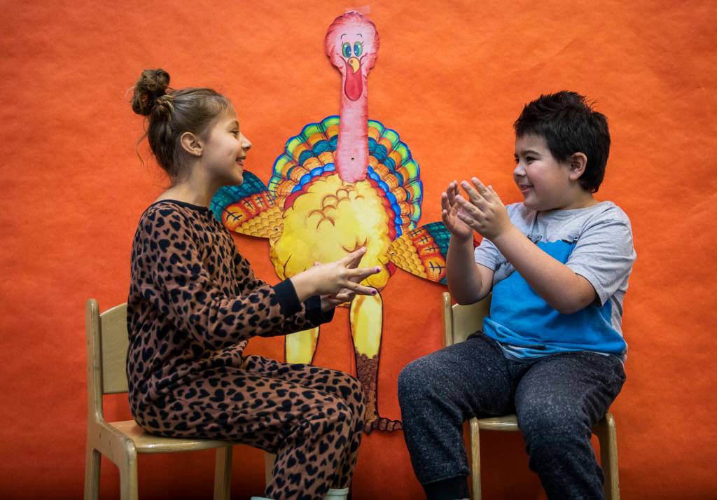 Nicolette Wythes, left, and Mateo Ellis, right, laugh as they try their best turkey impression at Central Primary School on Tuesday, Nov. 22, 2022 in Snohomish, Washington. (Olivia Vanni / The Herald)