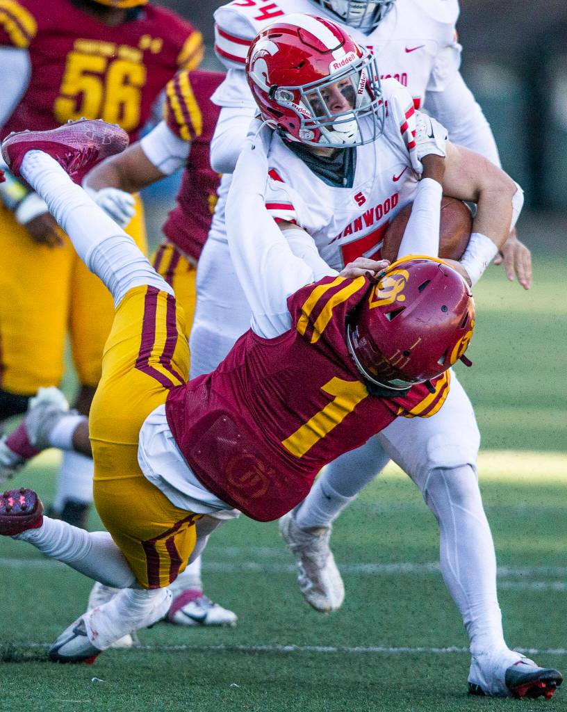 Stanwoods Ryder Bumgarner runs through a tackle during the 3A quarterfinal game against Odea on Saturday, Nov. 19, 2022 in Seattle, Washington. (Olivia Vanni / The Herald)