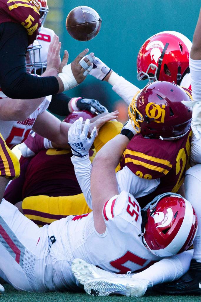 The ball pops loose after a hard tackle during the 3A quarterfinal game against Odea on Saturday, Nov. 19, 2022 in Seattle, Washington. (Olivia Vanni / The Herald)