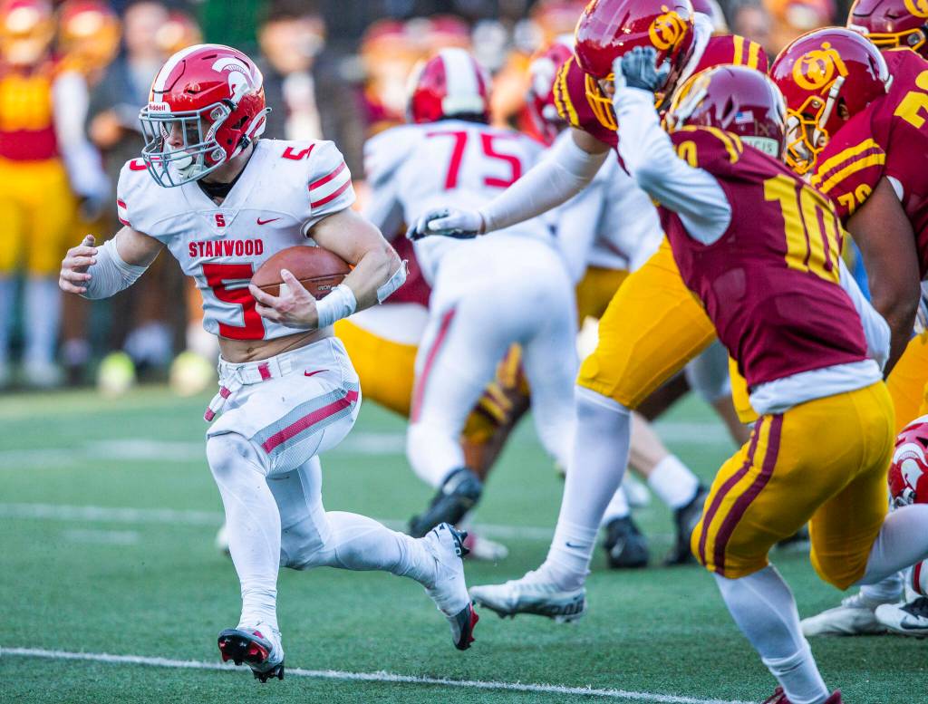 Stanwoods Ryder Bumgarner breaks free of multiple tackles while running the ball during the 3A quarterfinal game against Odea on Saturday, Nov. 19, 2022 in Seattle, Washington. (Olivia Vanni / The Herald)