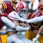 Stanwoods Ryder Bumgarner is tackled by multiple players while running the ball during the 3A quarterfinal game against Odea on Saturday, Nov. 19, 2022 in Seattle, Washington. (Olivia Vanni / The Herald)