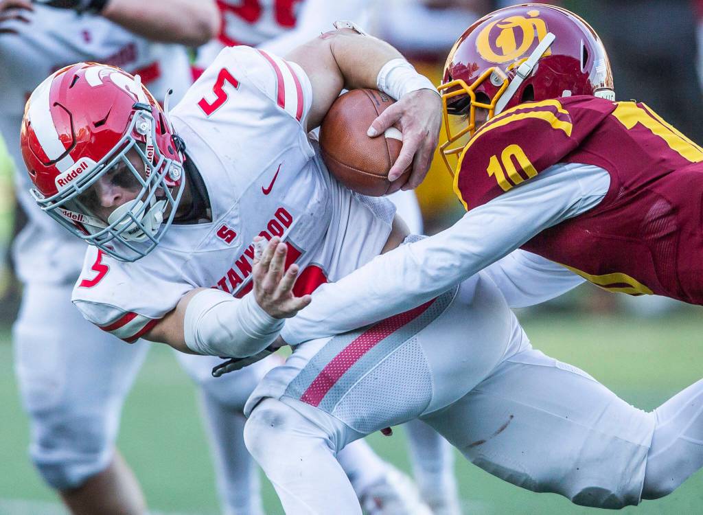 Stanwoods Ryder Bumgarner is tackled while running the ball during the 3A quarterfinal game against Odea on Saturday, Nov. 19, 2022 in Seattle, Washington. (Olivia Vanni / The Herald)
