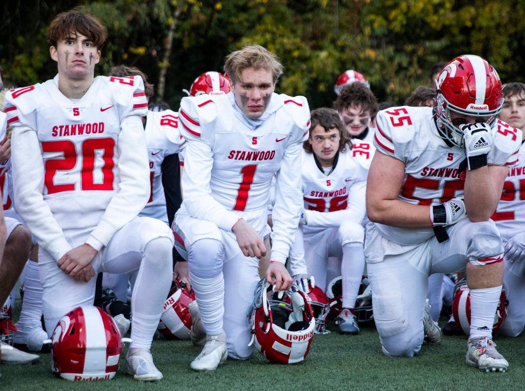 Stanwood players become emotional listening to their coaches after losing the 3A quarterfinal game against Odea on Saturday, Nov. 19, 2022 in Seattle, Washington. (Olivia Vanni / The Herald)