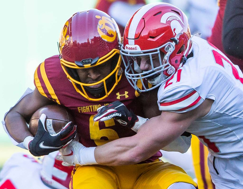 Stanwoods Otto Wiedmann grimaces while making a tackle during the 3A quarterfinal game against Odea on Saturday, Nov. 19, 2022 in Seattle, Washington. (Olivia Vanni / The Herald)
