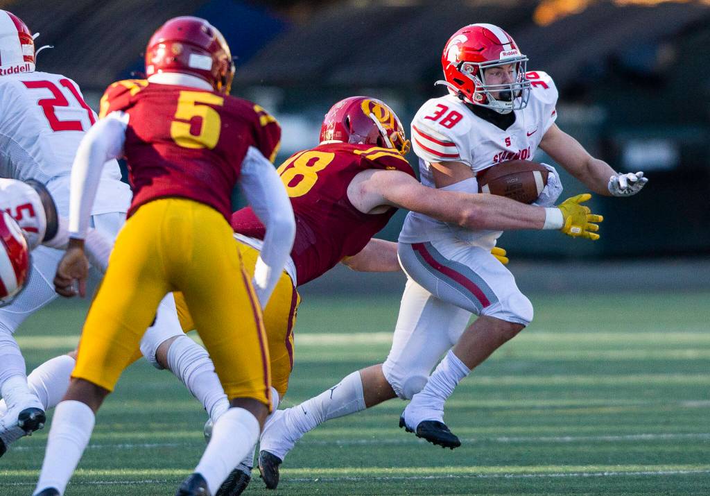 Stanwoods Carson Beckt is tackled while running the ball during the 3A quarterfinal game against Odea on Saturday, Nov. 19, 2022 in Seattle, Washington. (Olivia Vanni / The Herald)