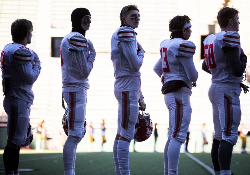 Stanwood player stand for the National Anthem before the start of the 3A quarterfinal game against Odea on Saturday, Nov. 19, 2022 in Seattle, Washington. (Olivia Vanni / The Herald)