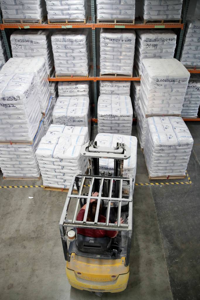 An employee stacks flour at Cairnspring Mills on Sept. 20, in Burlington. (Kevin Clark / The Herald)