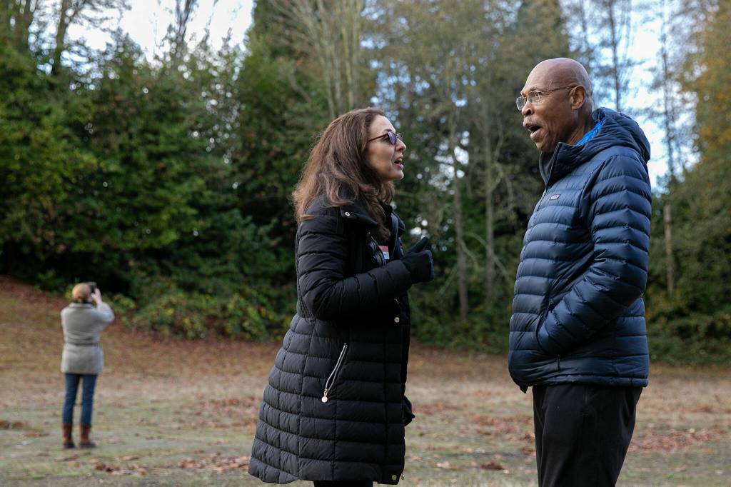 PAWS CEO Heidi Wills chats with Sen. John Lovick after the watch the release of a red-tailed hawk Wednesday, Nov. 23, 2022, at Evergreen Cemetery in Everett, Washington. (Ryan Berry / The Herald)