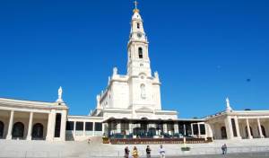 The towering Basilica of Our Lady of FÃ¡tima sits at the head of a vast esplanade. At the top of the steps, a covered open-air altar, cathedra (bishop's chair), and pulpit stand ready to conduct Mass to the thousands of pilgrims who come to celebrate the Virgin of FÃ¡tima on the 13th day of each month from May through October.