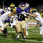 Lake Stevens Jayden Limar muscles through the defense against Bellevue on Sept. 9 in Lake Stevens. (Ryan Berry / The Herald)