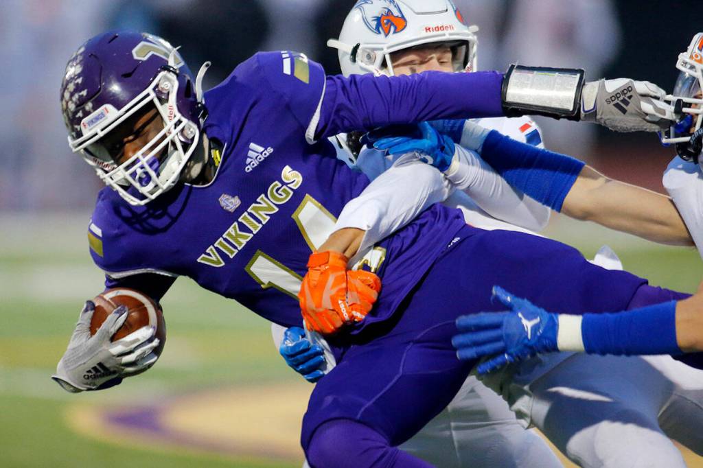 Lake Stevens’ Isaac Redford gets taken down after a catch during the 4A semifinal against Graham-Kapowsin on Saturday, Nov. 26, 2022, at Lake Stevens High School in Lake Stevens, Washington. (Ryan Berry / The Herald)