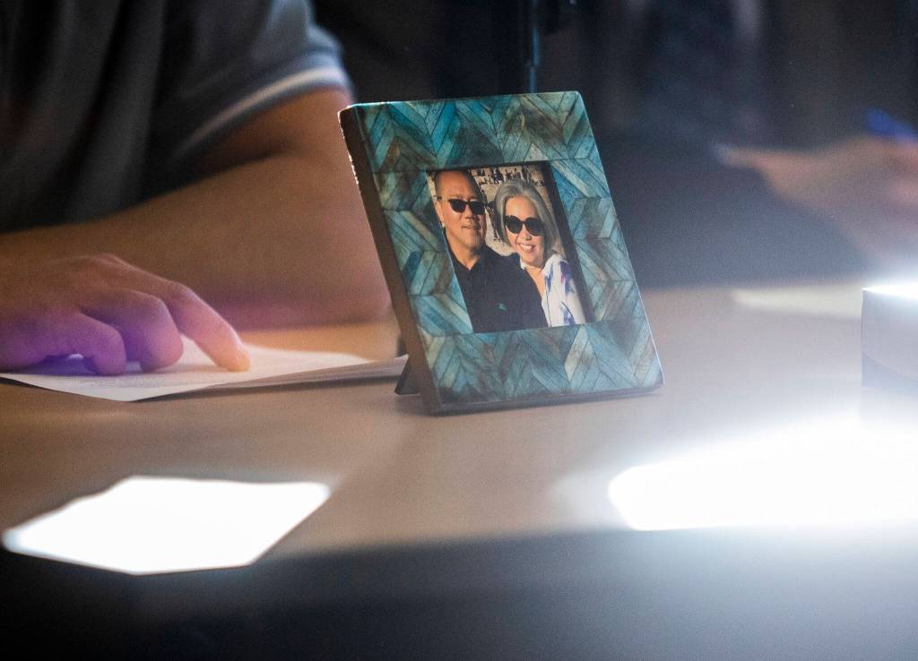 A framed photograph of Mila and Wilfrido Sarmiento is displayed during their grandsons reading of his victim impact statement to the court during Caleb Wrides sentencing on Monday, Nov. 28, 2022 in Everett, Washington. (Olivia Vanni / The Herald)