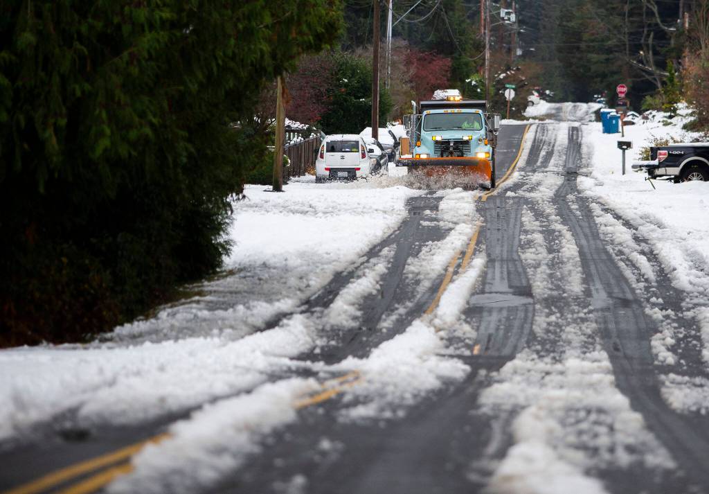 A snow plow clears snow off of 92nd Avenue West on Wednesday, Nov. 30, 2022 in Edmonds, Washington. (Olivia Vanni / The Herald)