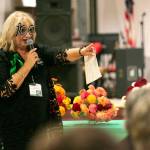 Janet Bacon leads the Giving Circle meeting of the 100+ Women Who Care About Snohomish County at the Sons of Norway Normanna Lodge in Everett. (Ryan Berry / The Herald)