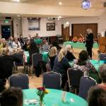 Janet Bacon speaks to a large crowd during 100+ Women Who Care About Snohomish Countys Giving Circle meeting at the Sons of Norway Normanna Lodge in Everett. (Ryan Berry / The Herald)