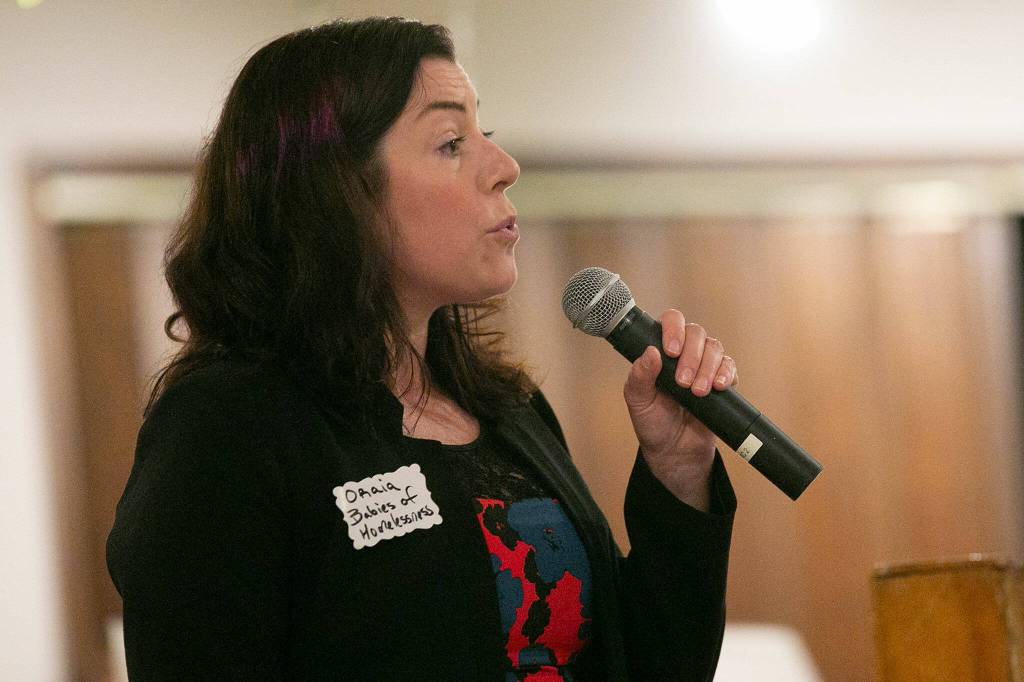 Oraia Reid from Babies of Homelessness gives a description of the organization during 100+ Women Who Care About Snohomish Countys Giving Circle meeting at the Sons of Norway Normanna Lodge in Everett. (Ryan Berry / The Herald)