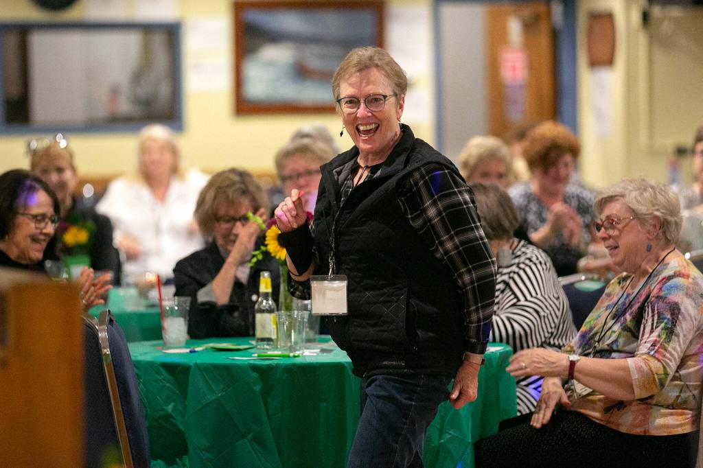 Members of 100+ Women Who Care About Snohomish County, wait to see if their raffle tickets are winners during their Giving Circle meeting at the Sons of Norway Normanna Lodge in Everett. (Ryan Berry / The Herald)