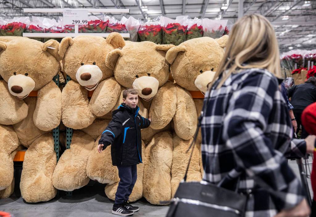 Gage Hestand, 10, tries to convince his mom to buy a large teddy bear at the new Costco in Lake Stevens on Friday. (Olivia Vanni / The Herald)