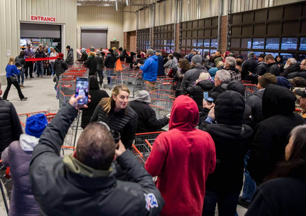 Costco shoppers wait in line to be the first inside the new store Friday in Lake Stevens. (Olivia Vanni / The Herald)