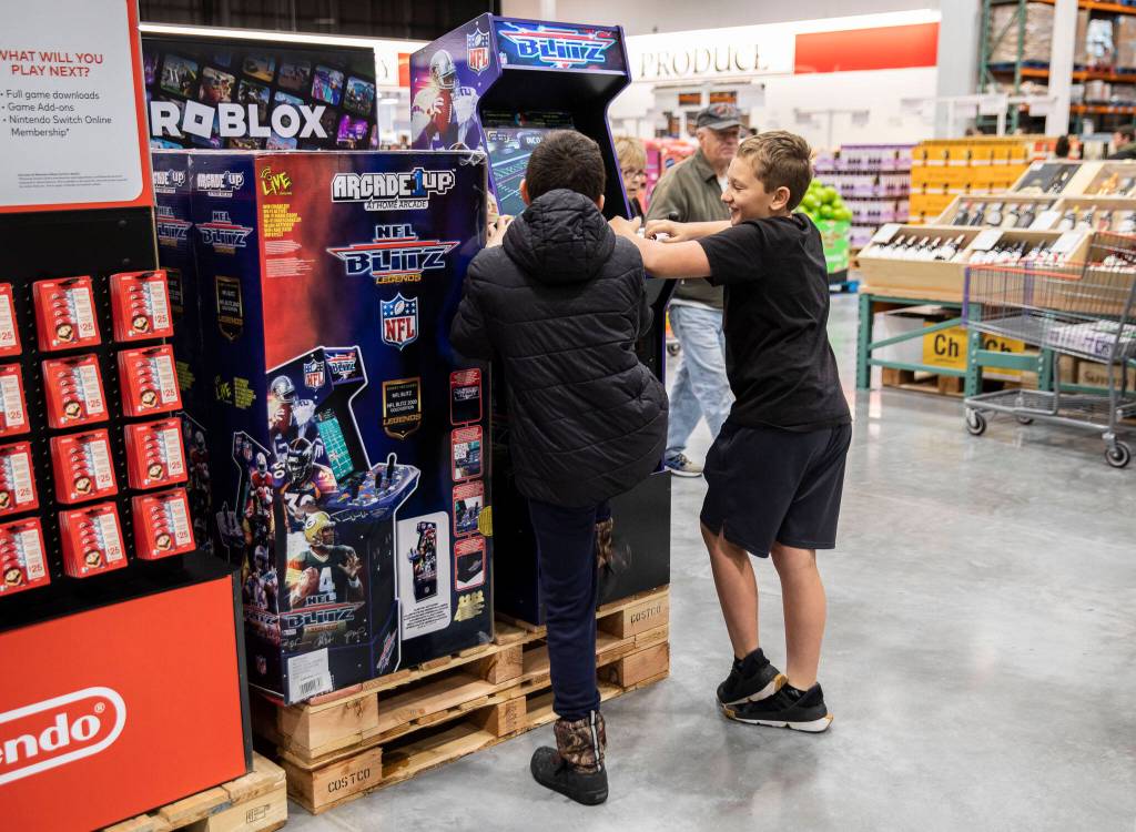 Two boys plays a video game display at Costco on Friday, Dec. 2, 2022 in Lake Stevens, Washington. (Olivia Vanni / The Herald)