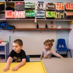 Riley, 7, and Harmony, 1, sit down for snack time at Tomorrows Hope Child Development Center in Everett. (Olivia Vanni / The Herald)