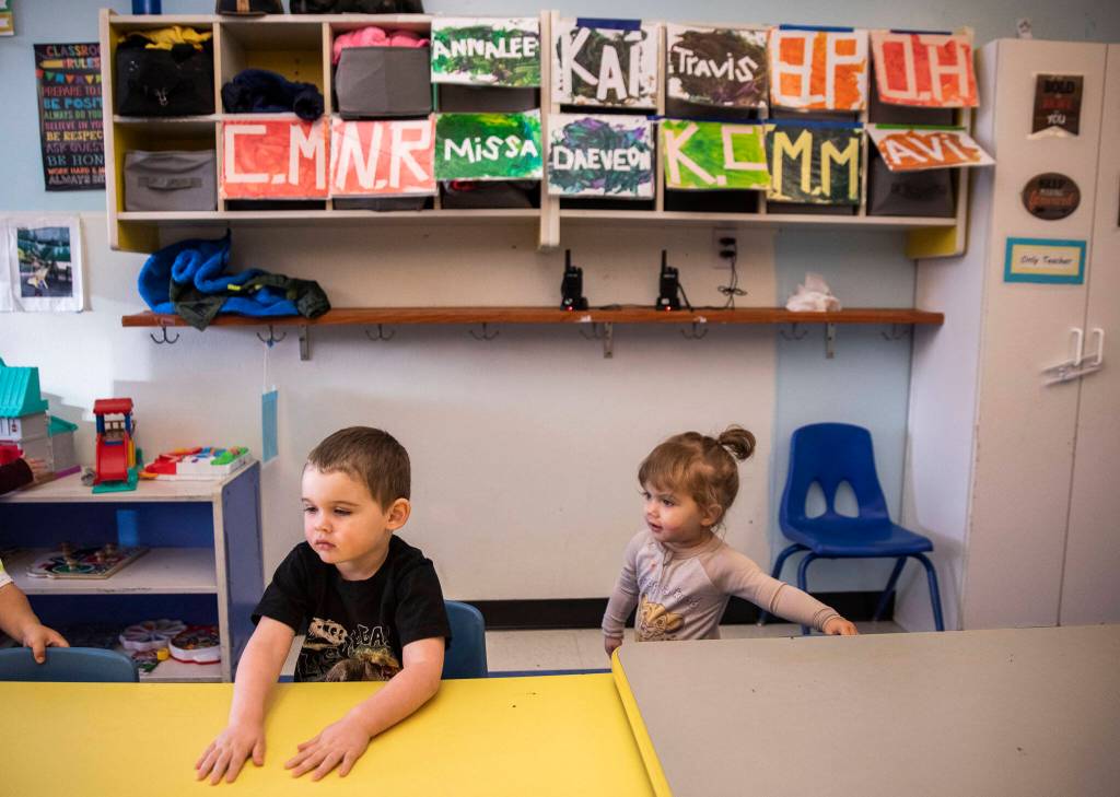 Riley, 7, and Harmony, 1, sit down for snack time at Tomorrows Hope Child Development Center in Everett. (Olivia Vanni / The Herald)