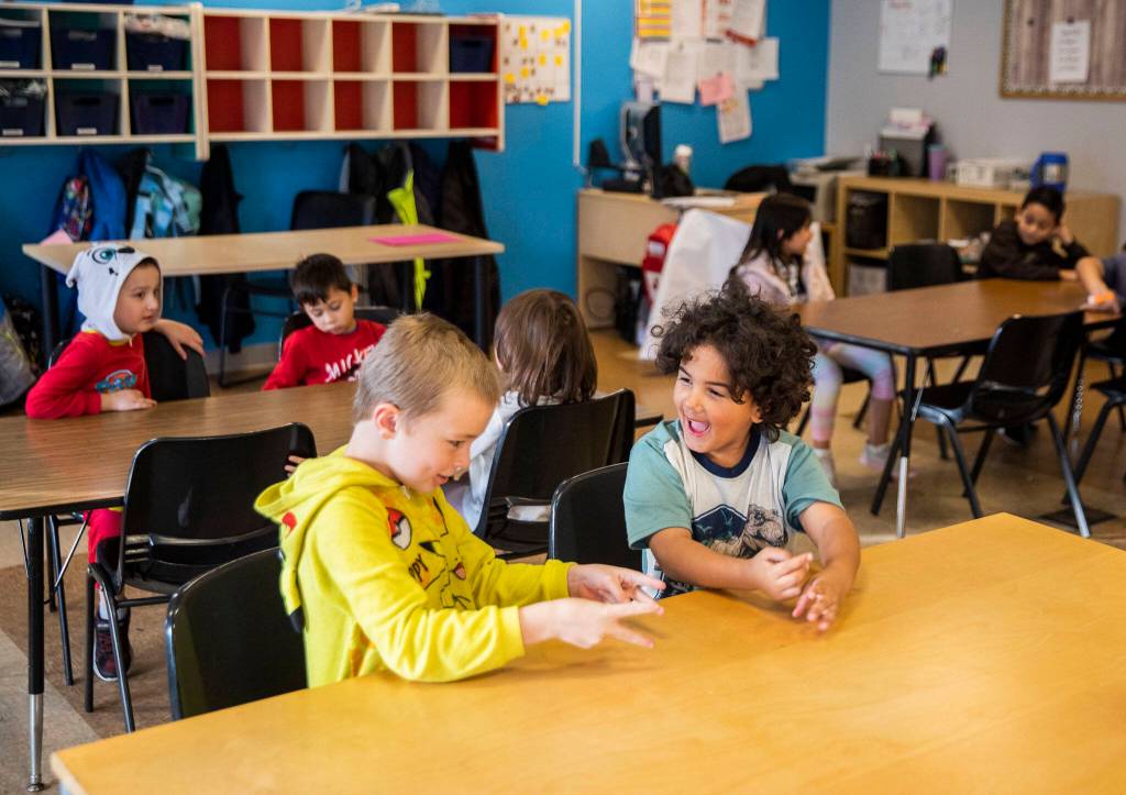 Riley, 7, left, and Under, 6, wait for breakfast at Tomorrows Hope Child Development Center in Everett. (Olivia Vanni / The Herald)