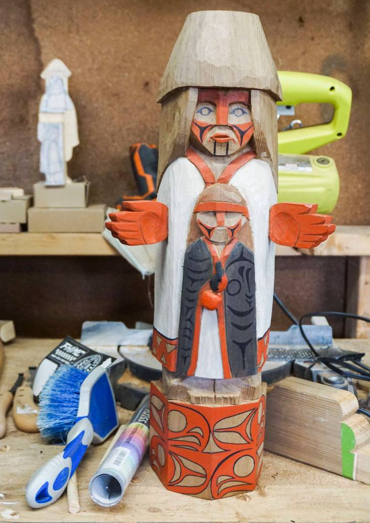 A small model of Ty Juvinels welcome figure sits on display in his workshop on Wednesday, Dec. 1, 2022 in Tulalip, Washington. (Kayla Dunn / The Herald)