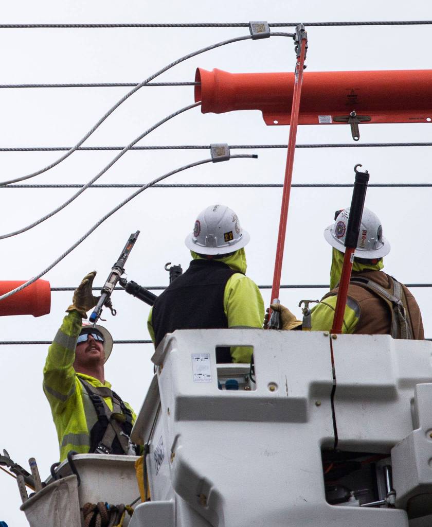 Snohomish County PUD workers install new transformers along 132nd Street Oct. 25 in Mill Creek. (Olivia Vanni / The Herald)