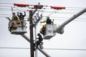 PUD workers install new transformers along 132nd Street on Tuesday, Oct. 25, 2022 in Mill Creek, Washington. (Olivia Vanni / The Herald)
