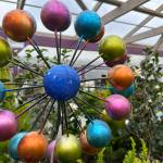 Colorful yard art like this spinner add interest to gardens -- making them great gifts for gardeners.