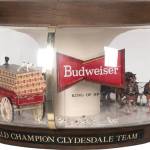 This advertising lamp includes figures of a team of horses pulling a beer cart with drivers, followed by a crowd of Dalmatians. Similar scenes may take place in real life on Budweiser’s promotional tours. The lamp with a moving wagon sold for $625.
