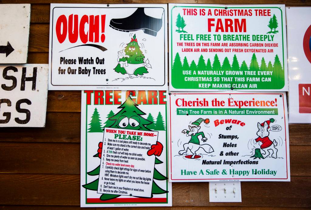 Signs alert customers to be aware of where they are walking at Pilchuck Secret Valley Tree Farm on Monday, in Arlington. (Olivia Vanni / The Herald)