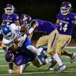 Lake Stevens linebacker Joe McGinnis (bottom) and nickelback Steven Lee Jr. (top) bring down a Federal Way ball carrier. (John Gardner / Pro Action Image)