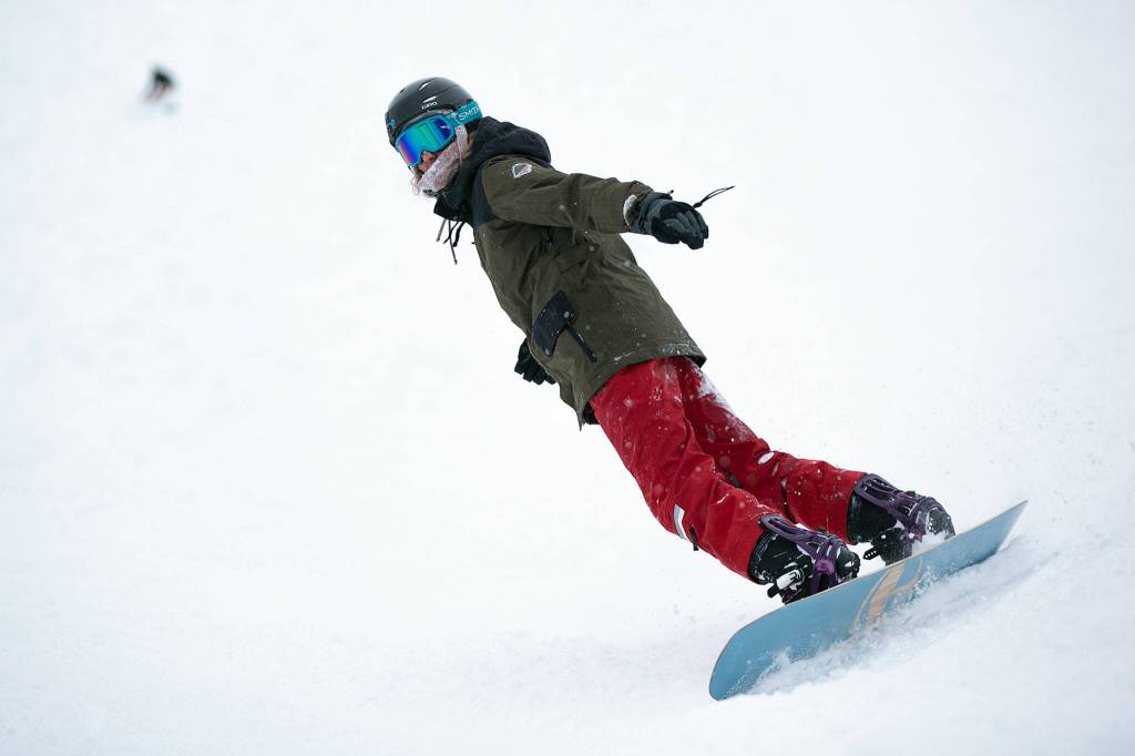 A snowboarder ends their run on the opening day of ski season. (Ryan Berry / The Herald)