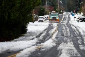 A snow plow clears snow off of 92nd Avenue West on Wednesday, Nov. 30, 2022, in Edmonds, Washington. (Olivia Vanni / The Herald)