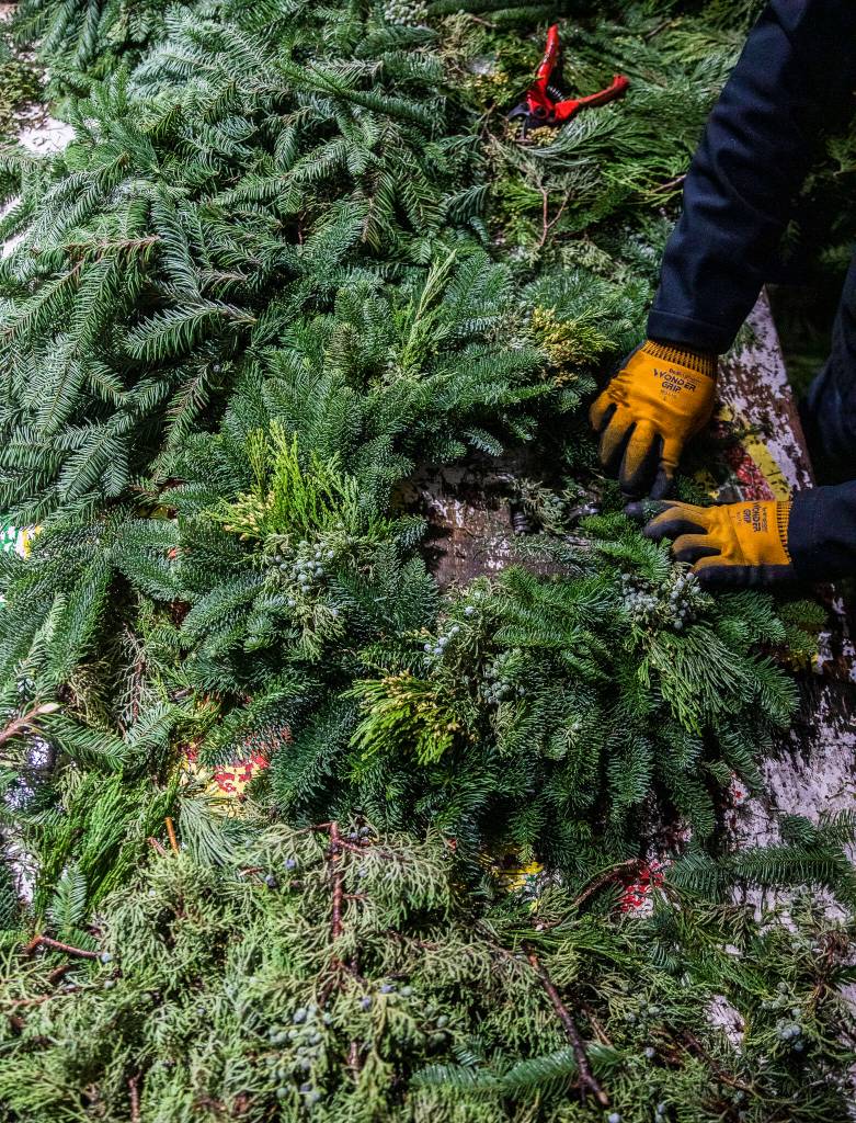 Franco Montano works on putting together a wreath at his workshop on Dec. 5, in Monroe. (Olivia Vanni / The Herald)