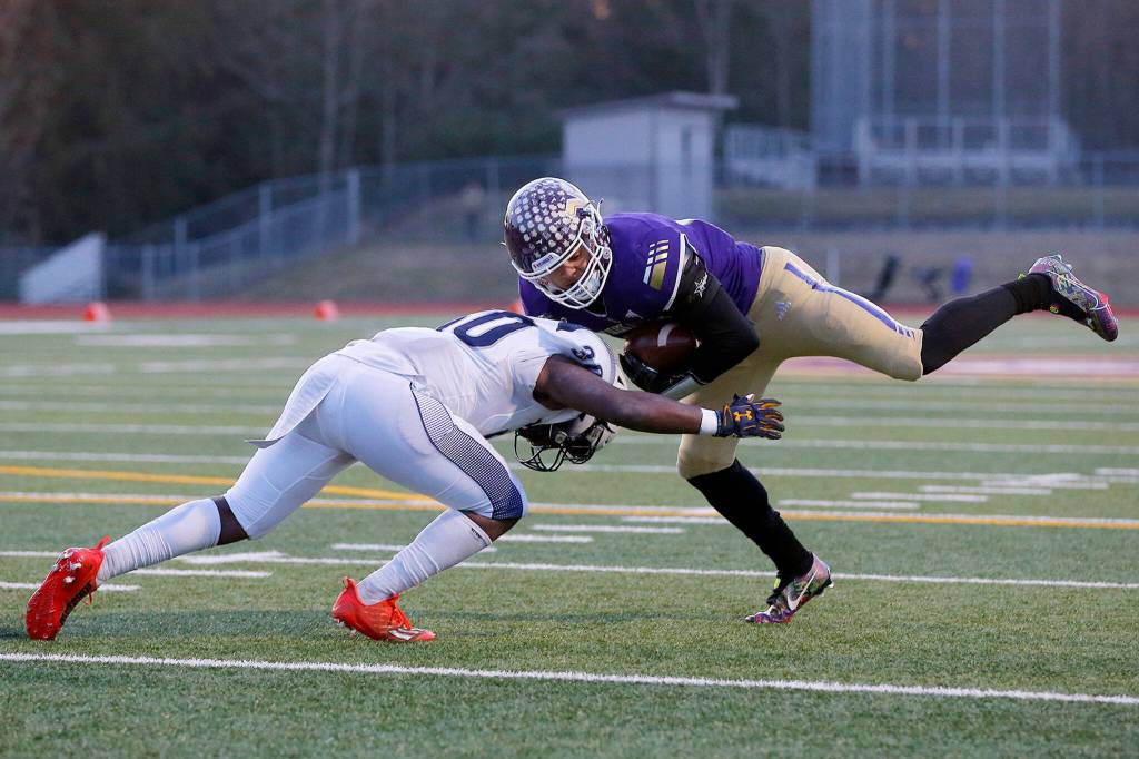 Lake Stevens’ Jayden Limar gets thrown off his feet while nearly scoring a touchdown against Gonzaga Prep on Saturday, Nov. 19, 2022, at Lake Stevens High School in Lake Stevens, Washington. (Ryan Berry / The Herald)